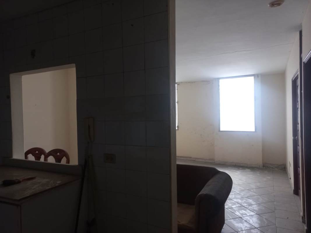 Simple kitchen with white tiles, stainless sink, utility sink, window and countertop PH Plaza de Trafalgar