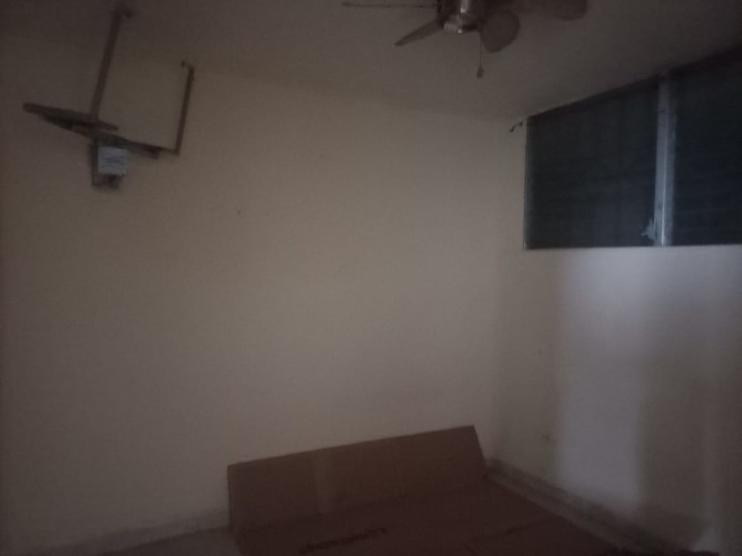 Bedroom with tiled floors, window with grille, natural light in PH Plaza de Trafalgar Carrasquilla Panama