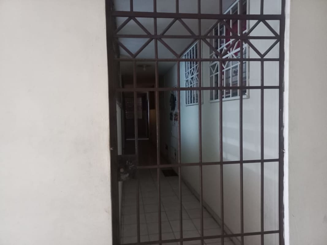 Interior corridor with metal gate, barred windows tiled floor PH Plaza de Trafalgar Carrasquilla Panama