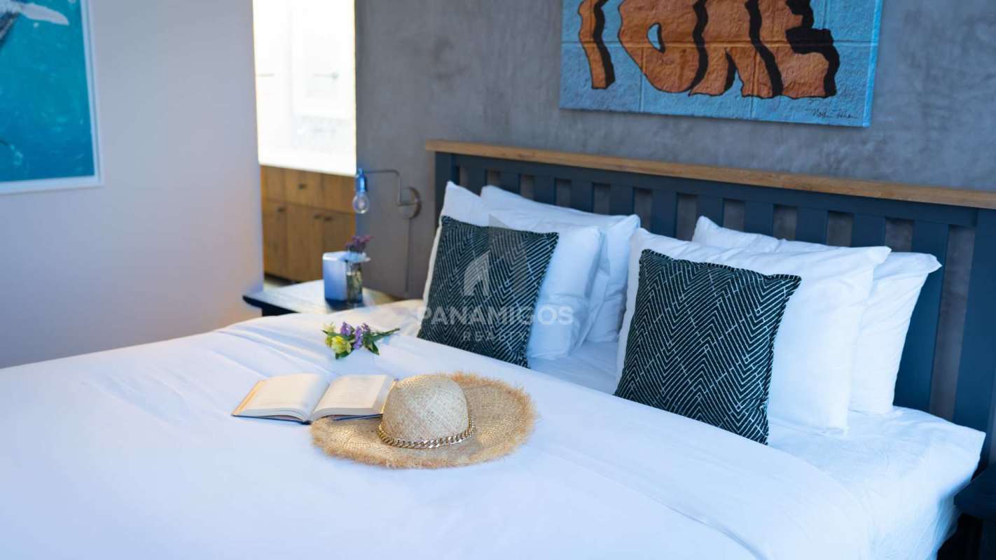 Open kitchen with green tiled backsplash and quartz countertop at Casco View Casco Viejo Panama