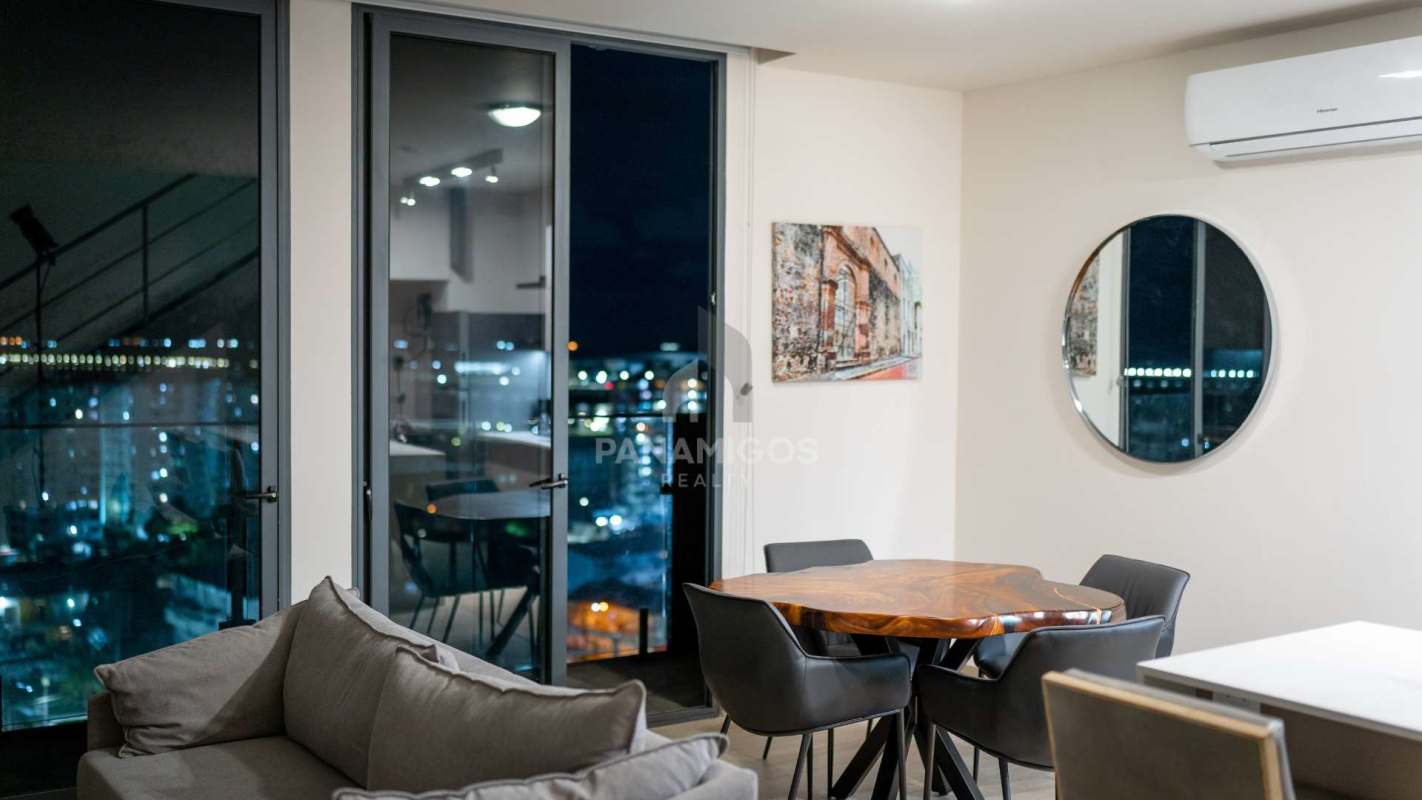 Open plan living dining room with large windows night city view Casco View Casco Viejo Panama