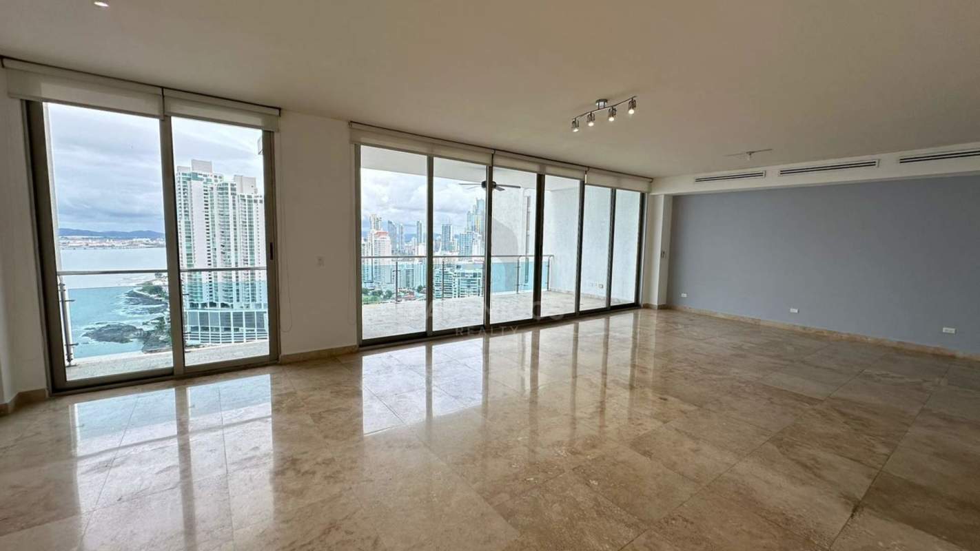 Kitchen with dark wood cabinets, granite countertops and large windows in PH Aqualina Punta Pacifica Panama