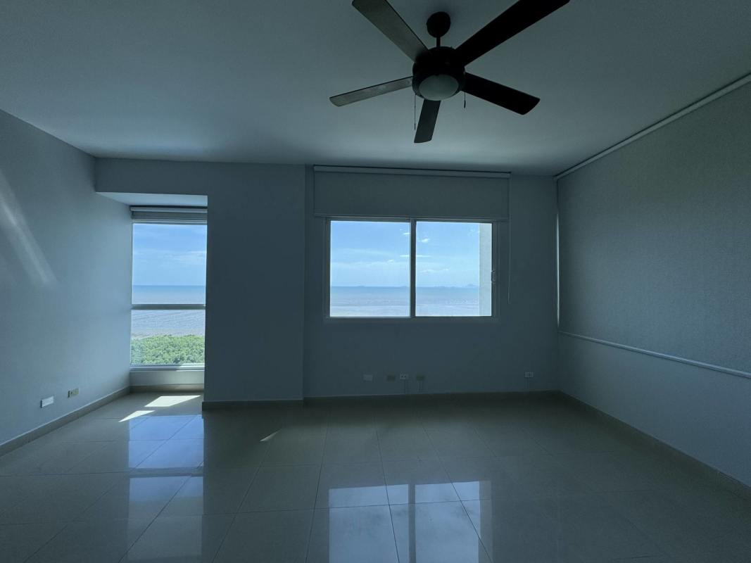 Empty living room with floor-to-ceiling windows and expansive Pacific Ocean views at PH Torre Zeus Costa del Este