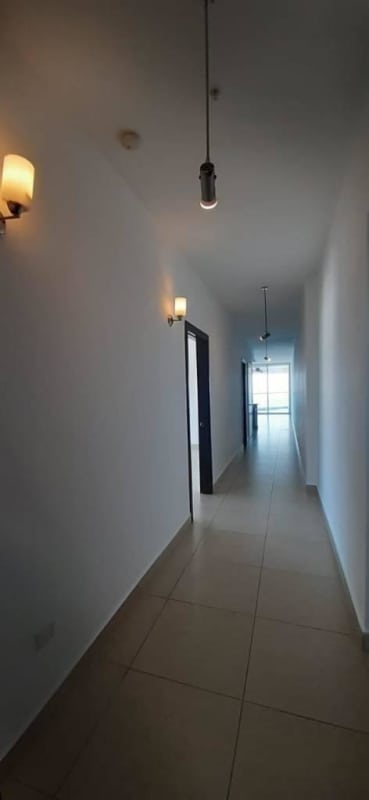 Bedroom with large windows overlooking Panama City skyline at Rivage Tower Avenida Balboa