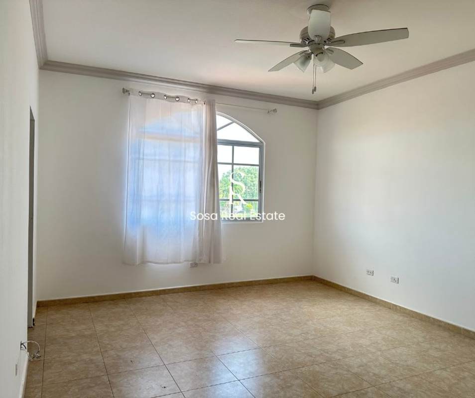 Unfurnished spacious bedroom with arch window and porcelain floors Costa del Este Panama