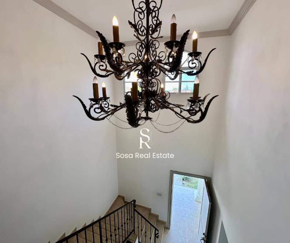 Entry foyer with wrought iron chandelier and staircase in rental house Costa del Este Panama