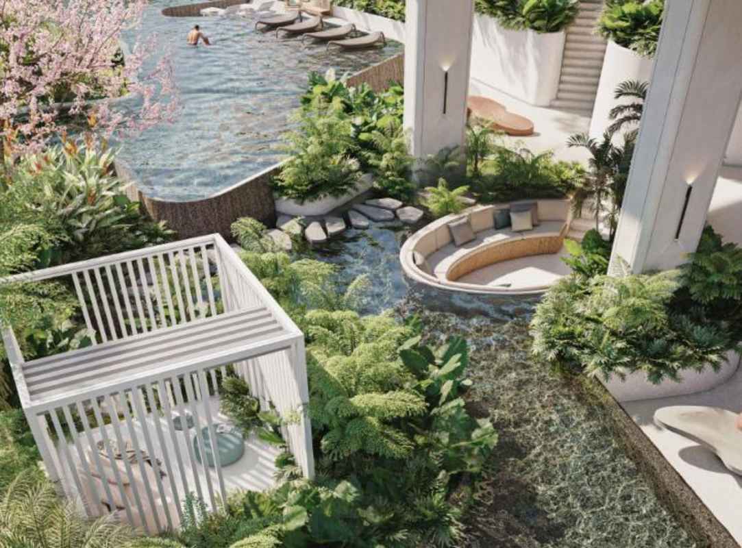 Infinity pool surrounded by lush gardens and sun loungers at PH Bioma Panama