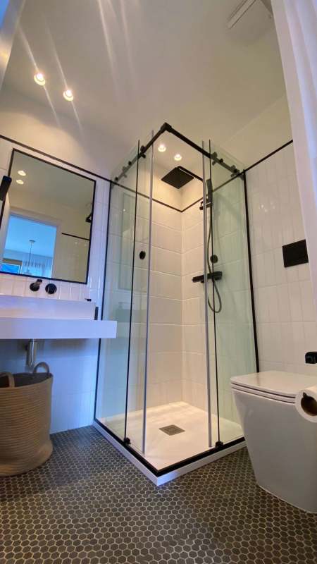 Minimalist bathroom with black fixtures and rainshower at NOOK Bella Vista Panama