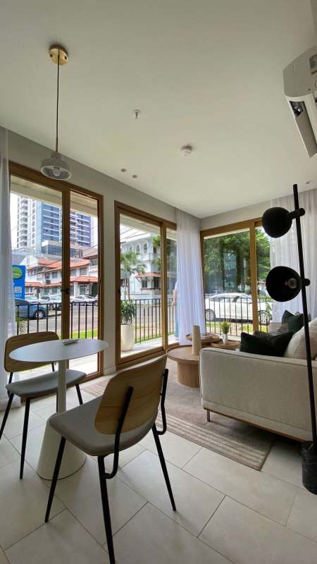 Living space with large windows, light decor overlooking city in NOOK Bella Vista