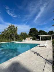 Modern single-level house with attached carport green lawn in PH Jardines Espino de la Rosa Santiago Panama