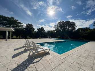 Bright bedroom with tiled floor large window AC unit at PH Jardines Espino Santiago Panama