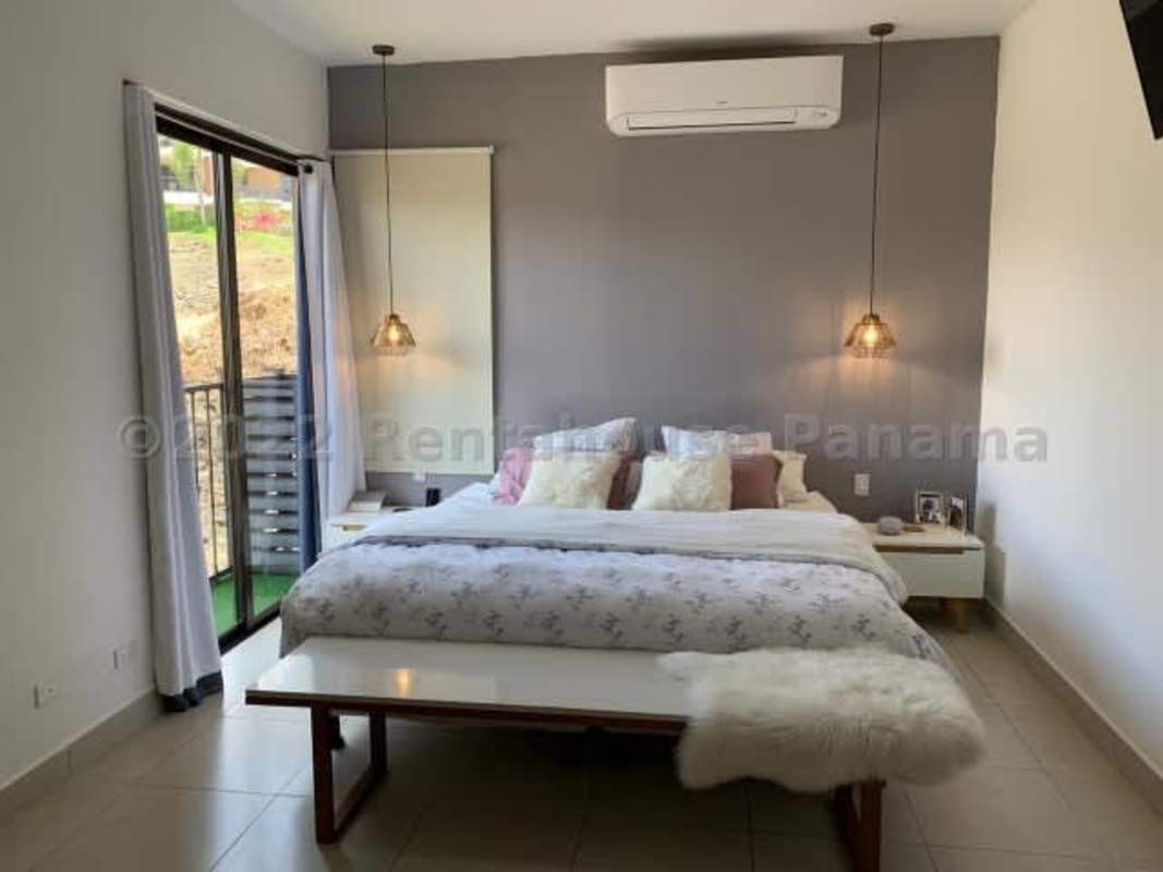 Resort-style swimming pool with palm trees and sun lounge chairs in Clayton Panama