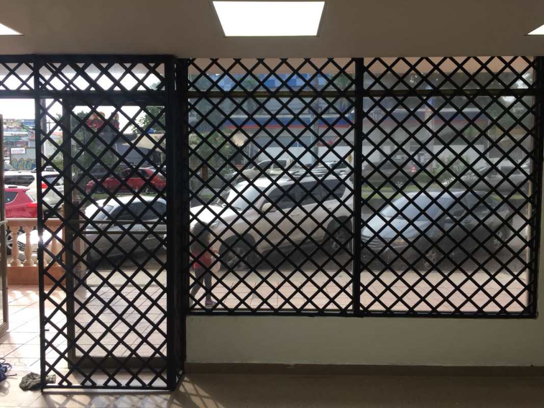 Front glass entrance with metal security grilles storefront PH Kitaen La Cresta Panama