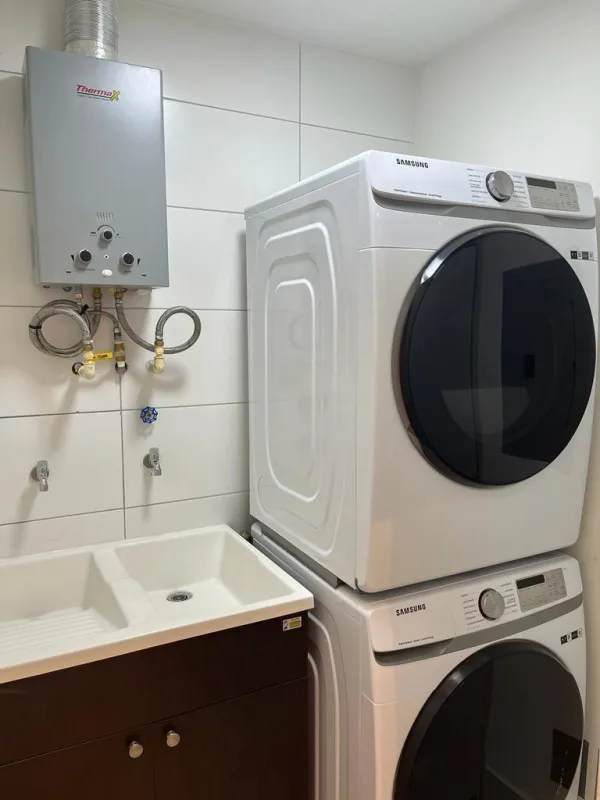 Laundry area with Samsung washer dryer and tankless heater PH Coco Place Panama