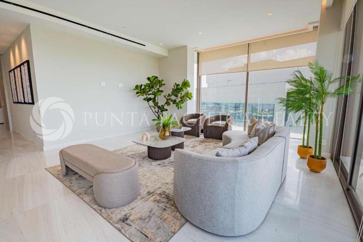 Spacious living room with floor-to-ceiling windows, designer furniture, golf view in La Maison Fendi Santa Maria Panama