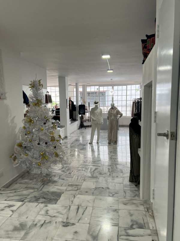 Bright showroom with mannequins and marble floor inside workshop/studio Obarrio Panama