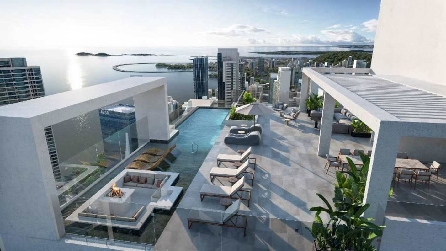 Rooftop terrace with infinity pool overlooking ocean and city skyline at PH La Costanera Panama City