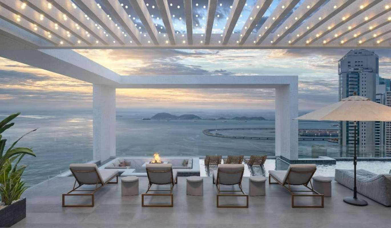 Elegant rooftop infinity pool lounge overlooking Panama City skyline and Pacific Ocean