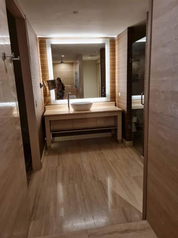 Contemporary bathroom with illuminated mirror and vessel sink at Panamera Residences for rent