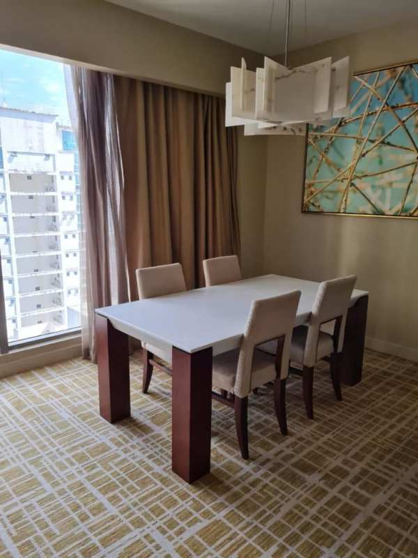 Bright open-plan living dining area with city views at Panamera Residences renting in Panama