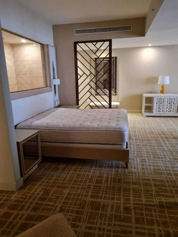 Modern bathroom with glass shower and vessel sink at Panamera Residences