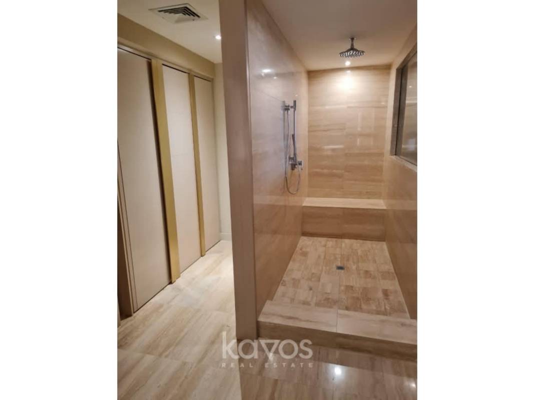 Modern bathroom with vessel sink glass enclosure at Waldorf Astoria Panama