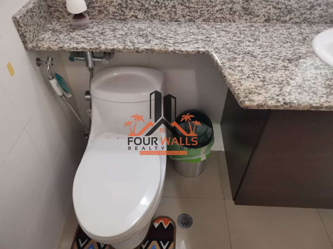 Minimalist design bedroom with large window, orange bedding, and AC in PH Citrus San Francisco