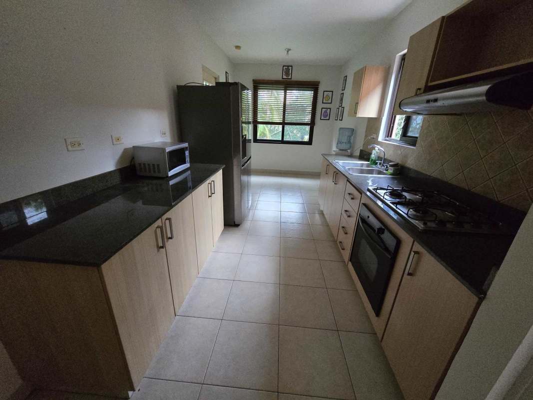 Spacious modern kitchen with granite countertops, appliances and large window PH Versalles Panama City