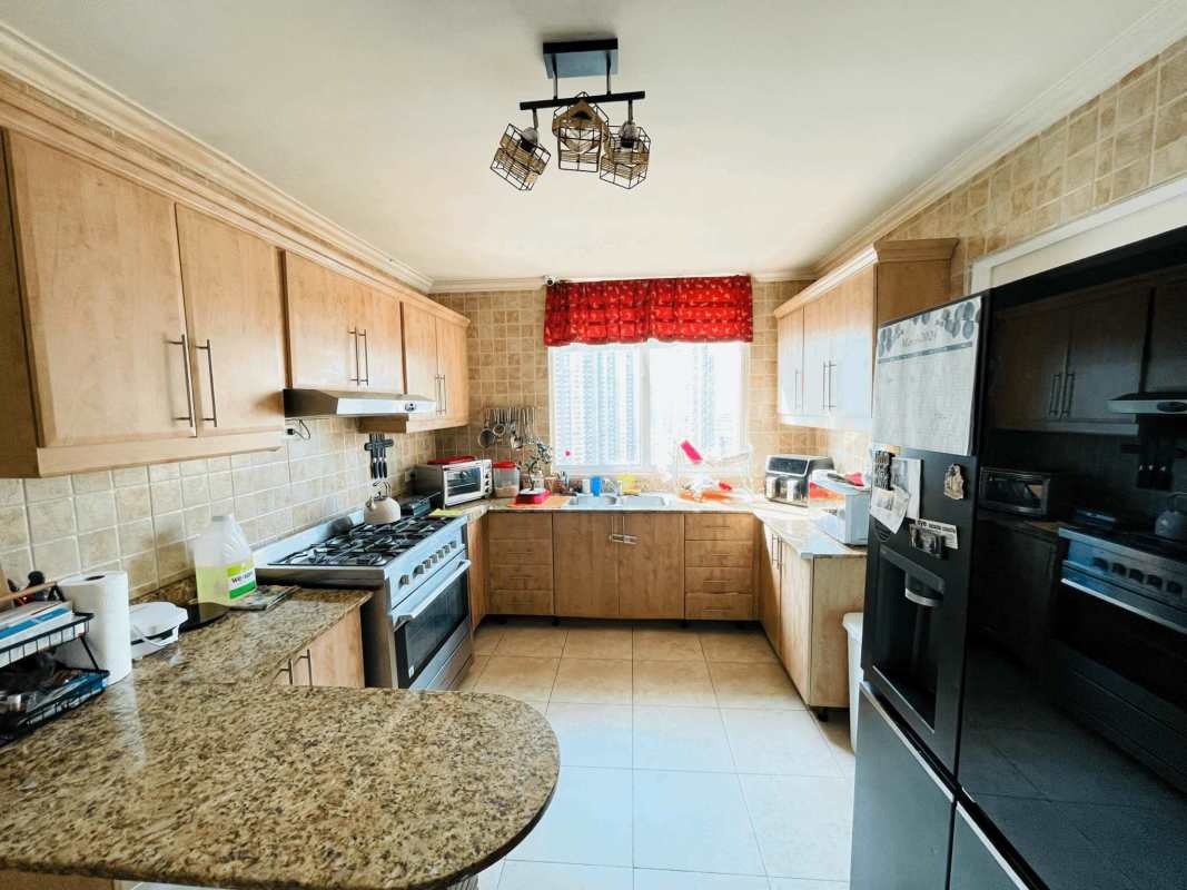 Infinity swimming pool area with gazebo overlooking ocean and skyscrapers PH Pacific Point Panama City