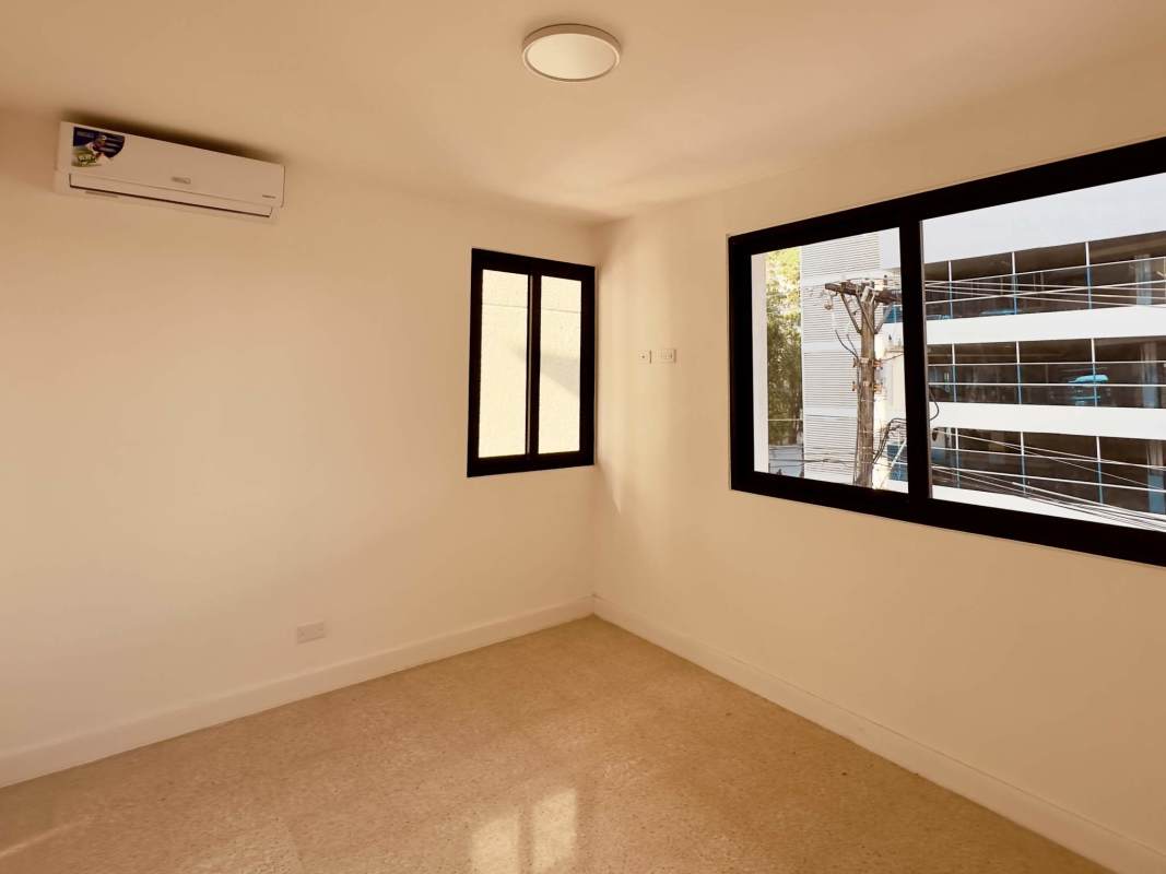 Modern living room with large sliding doors leading to balcony in PH El Cangrejo Panama City