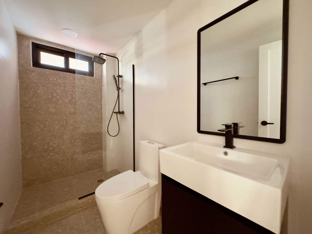 Minimalist bathroom with walk-in rain shower, modern sink and mirror PH El Cangrejo Panama