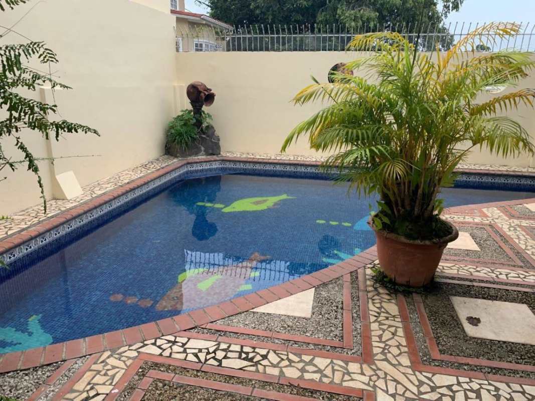 Mediterranean-inspired backyard pool with tropical landscaping Villa de Las Fuentes Panama City