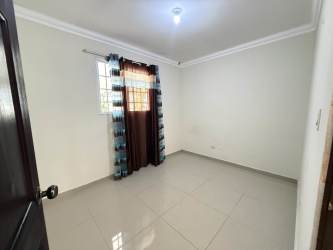 Spacious bedroom with large dark wood closet and tiled flooring Cantarrana Chitré Panama