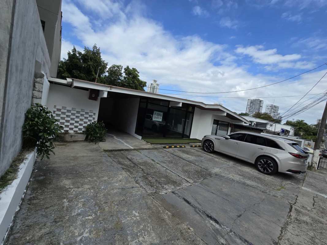 Single-story commercial building with security gate parking and signage San Francisco Panama