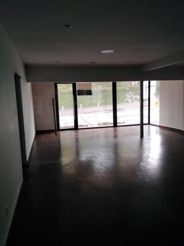 Spacious open-plan commercial interior with polished floor and large windows in Panama City