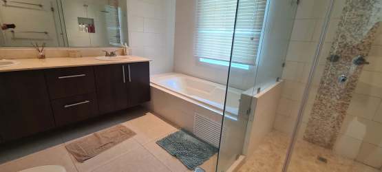 Open living and dining area with sliding doors to golf view terrace in Bijao Beach Resort Panama