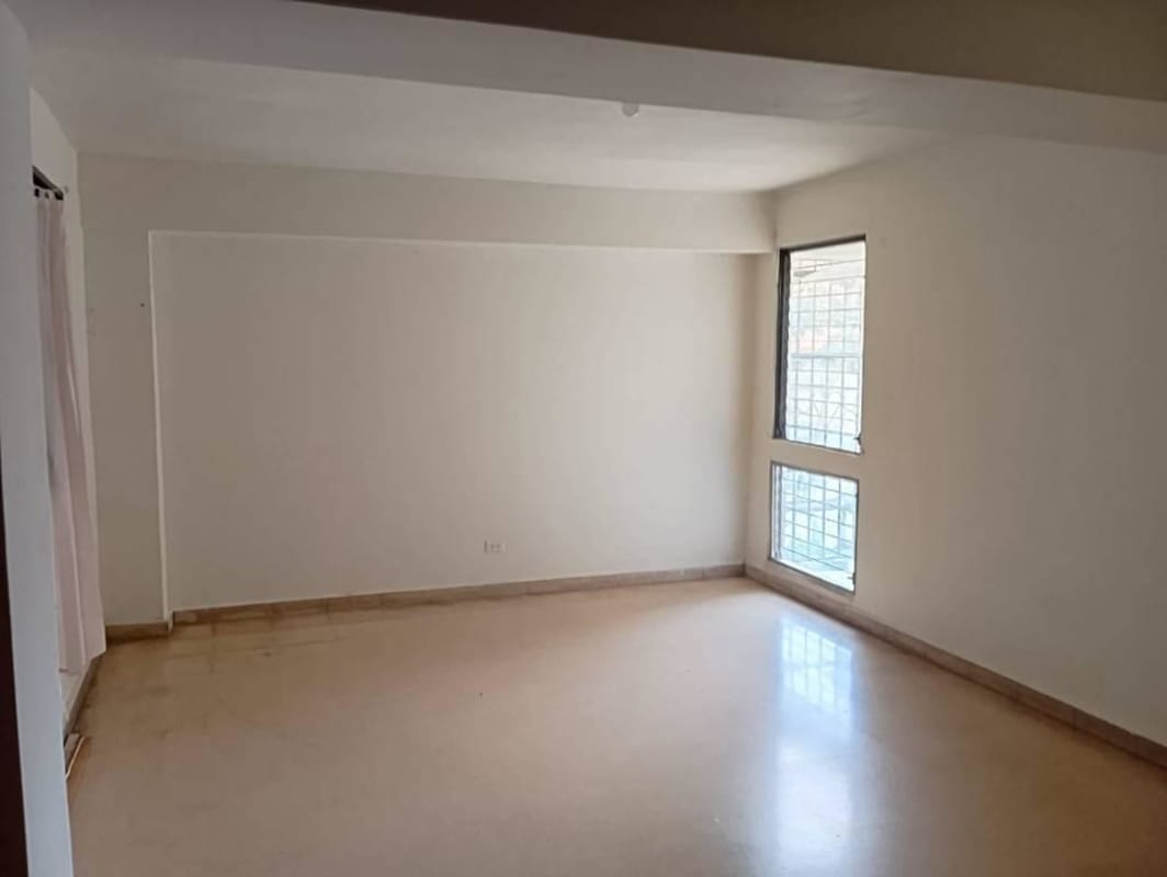 Spacious living room with windows in Bella Vista apartment for sale