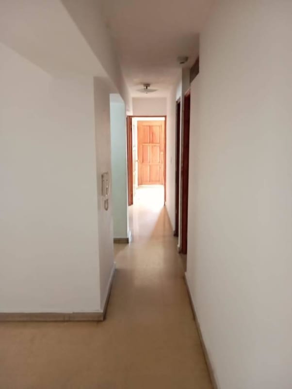 Long minimalist hallway with tile flooring in Bella Vista apartment Panama