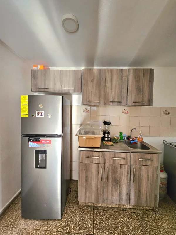 Contemporary kitchen refrigerator, wood cabinets, tile backsplash in San Francisco Panama rental