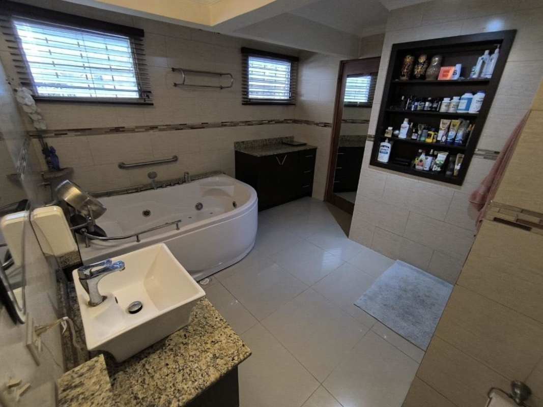 Contemporary bathroom with large corner jacuzzi, granite counters in Chanis remodeled home Panama