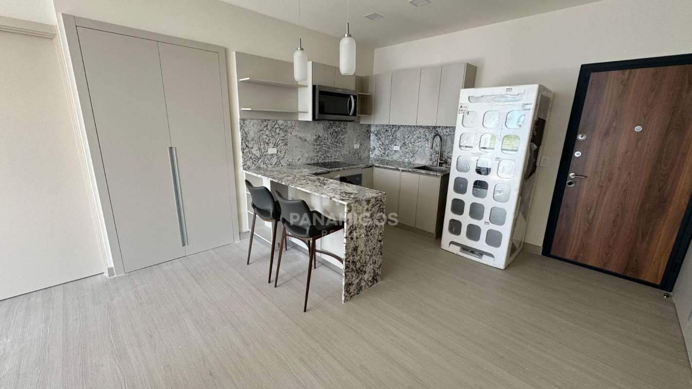 Compact modern kitchen with marble counters and breakfast bar in PH Arcadia Costa del Este Panama