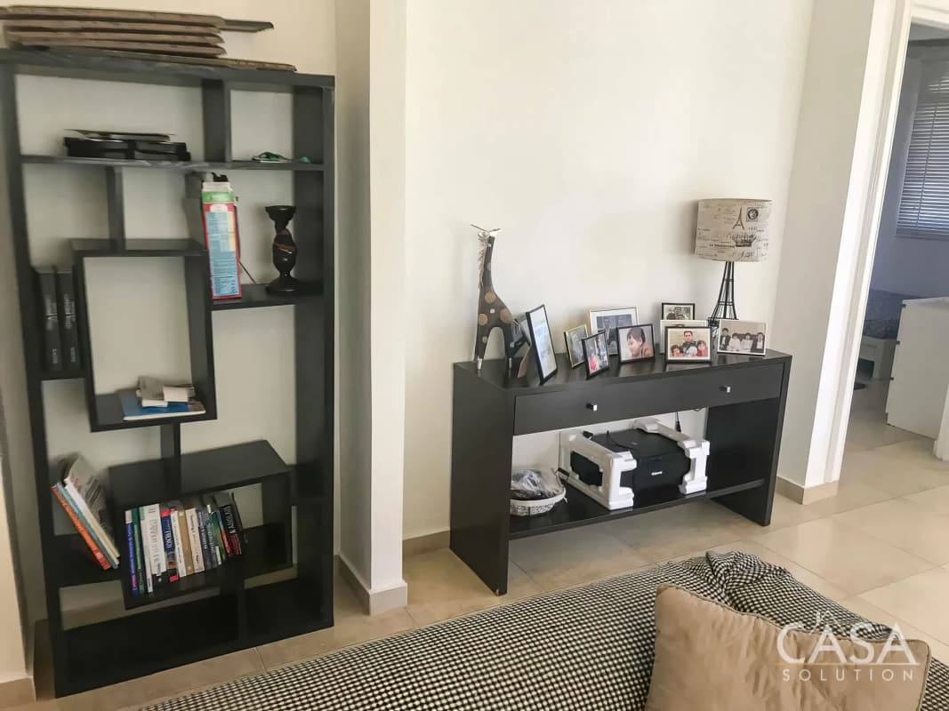 Contemporary hallway and bookcase with artwork in PH Clayton Village Panama City house