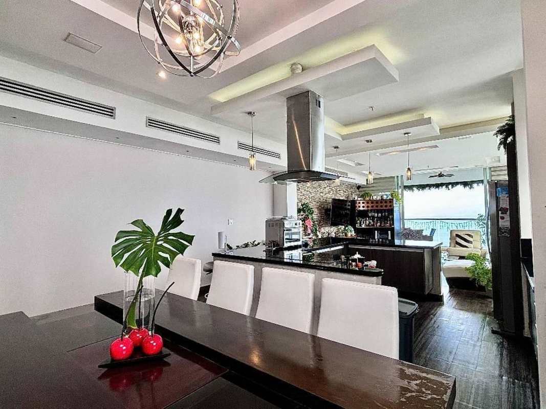 Contemporary kitchen with island, luxury appliances, open to dining and ocean view in PH Rivage Panama