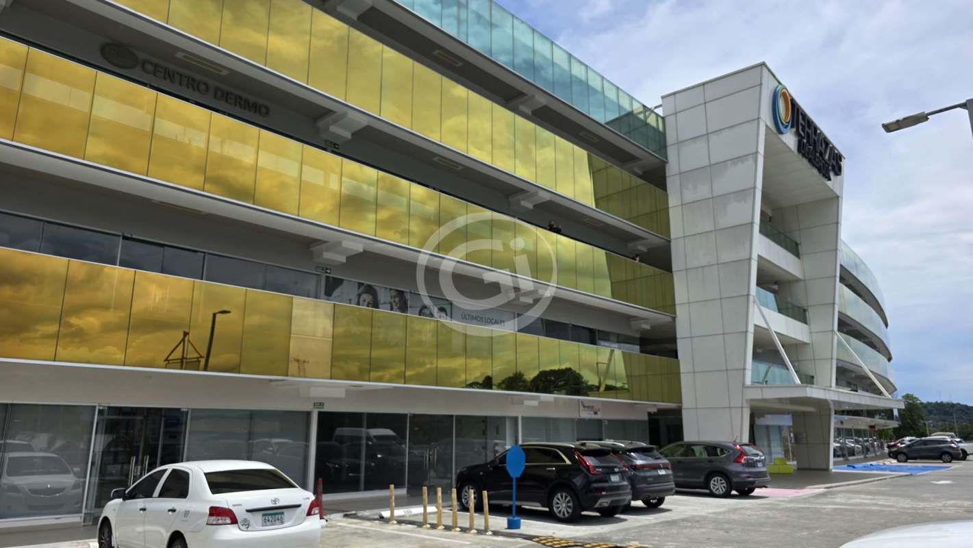 Gray shell commercial interior with exposed ceiling, sprinkler system, and large storefront windows in Terrazas de Albrook Panama