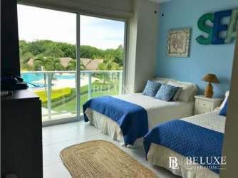 Coastal bedroom with large windows and pool view at PH Bijao Residences Panama