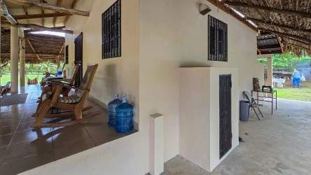 Covered porch with garden, rocking chairs and tropical setting Playa La Colorada