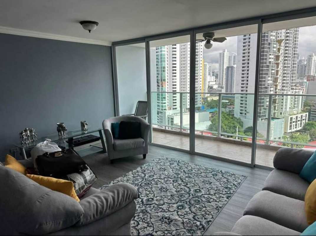 Contemporary living room with full-height windows and stunning city skyline view at PH Terramar in San Francisco Panama