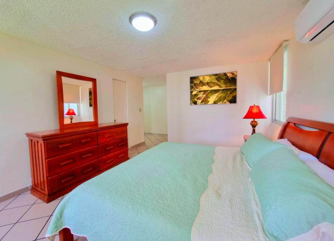 Kitchen with granite countertops, white cabinets and ceramic backsplash PH Bahia Marbella