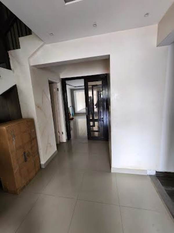 Modern hallway with wooden stairs, dark wooden doors, glass elements at Condado del Rey townhouse Panama