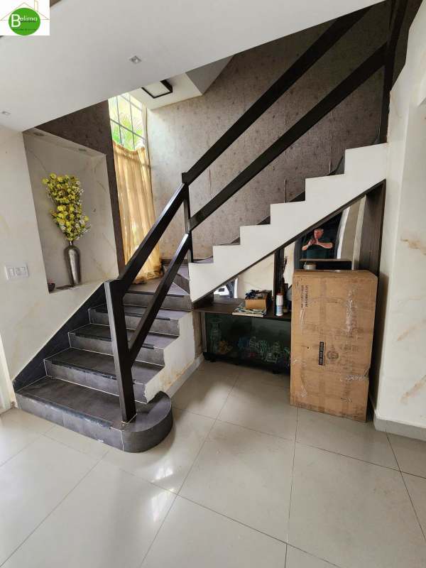 Modern kitchen with island counter, black cabinetry and tile flooring at The Springs Condado del Rey